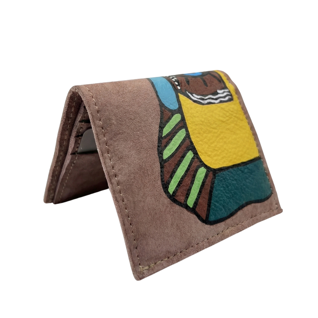 Hand-painted beige leather wallet with cubist abstract portrait, green cheek, and white polka dots. Signed by Rime Sbai.