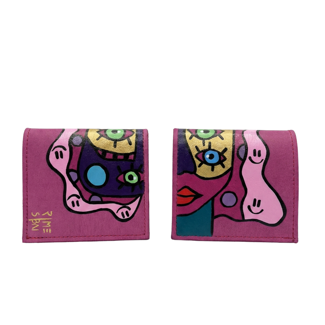 Hand-painted pink leather wallet with cubist abstract portrait, green cheek, and white polka dots. Signed by Rime Sbai.