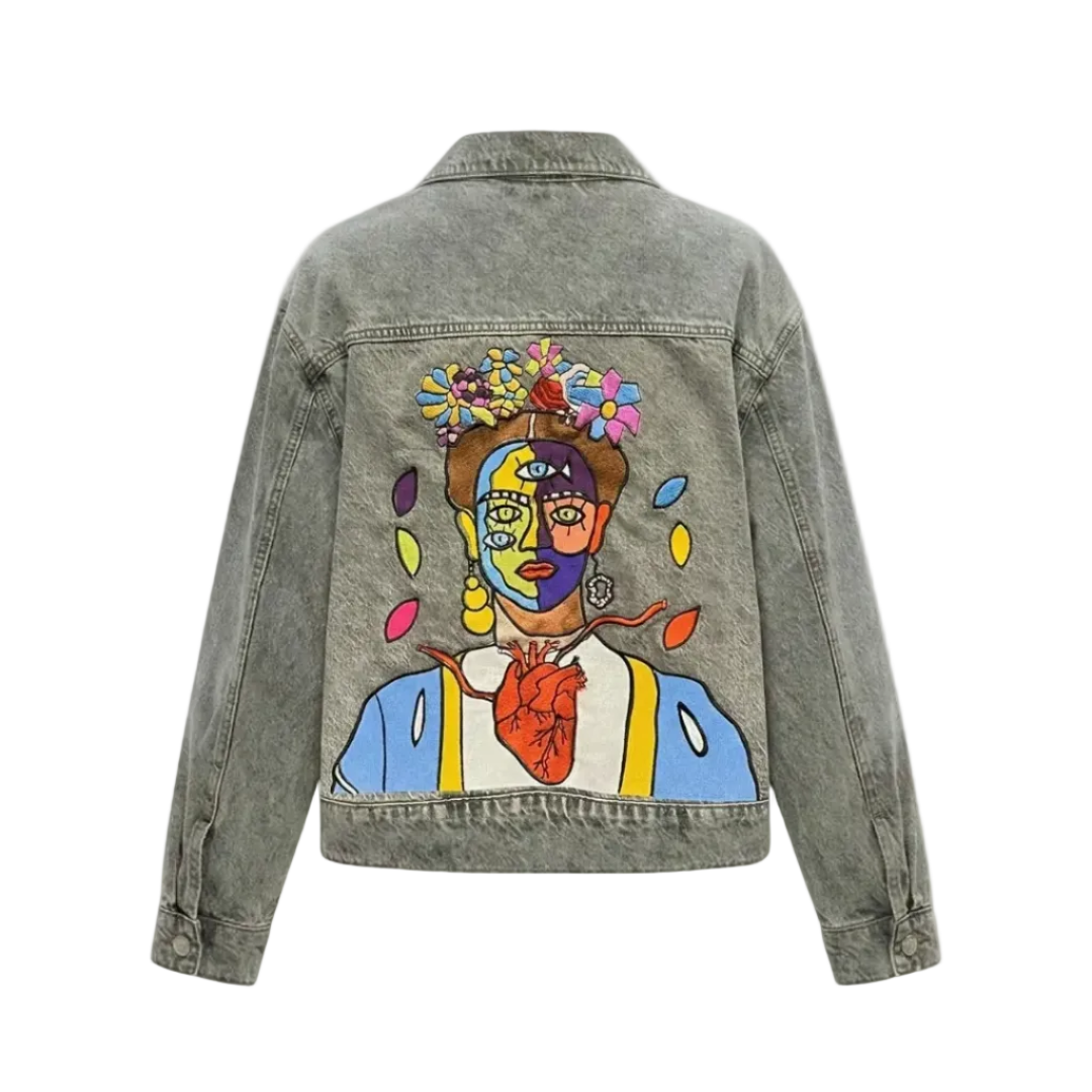 High-density colorful surrealist embroidery of Frida's Heart on the back of a grey denim jacket.